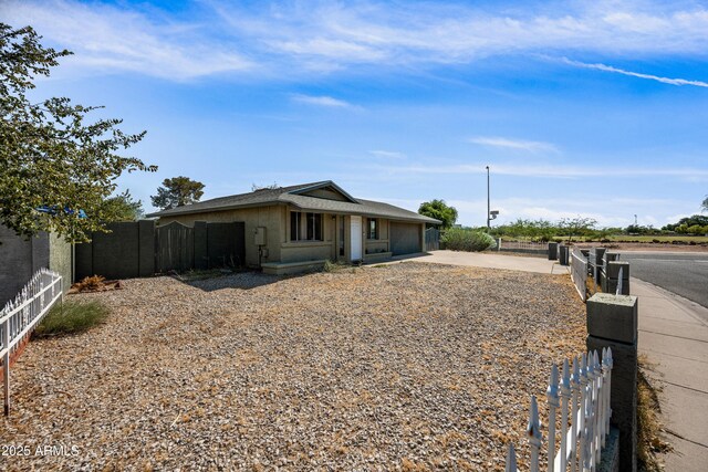 6171 W Mckinley St, Phoenix, AZ 85043 - view of front of house featuring driveway, a garage, and fence