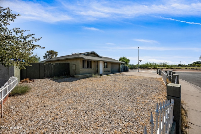 6171 W Mckinley St, Phoenix, AZ 85043 - view of front of property with an attached garage, concrete driveway, stucco siding, and fence