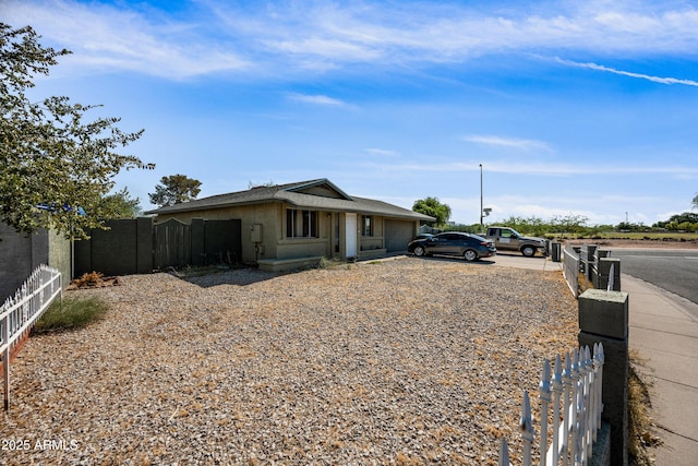 6171 W Mckinley St, Phoenix, AZ 85043 - view of front of home with an attached garage, fence, and driveway
