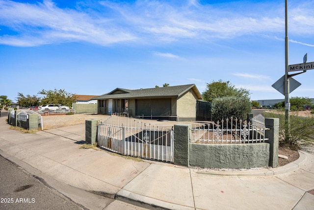 6171 W Mckinley St, Phoenix, AZ 85043 - view of front of property with a gate, concrete driveway, a fenced front yard, and a garage