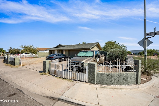 6171 W Mckinley St, Phoenix, AZ 85043 - view of front facade featuring concrete driveway, a garage, a gate, and a fenced front yard
