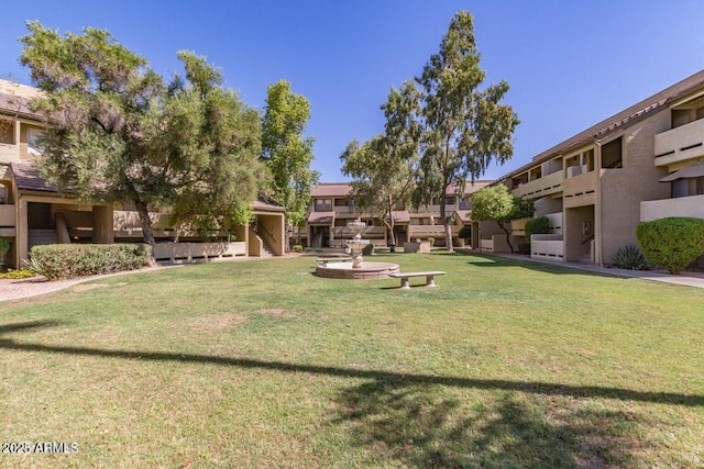 view of property's community featuring a lawn