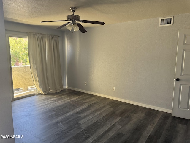 empty room with a textured ceiling, ceiling fan, and dark wood-type flooring