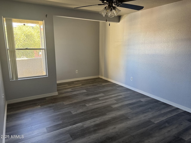 spare room with dark hardwood / wood-style floors and ceiling fan