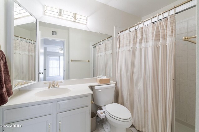 bathroom with toilet, vanity, and a shower with shower curtain