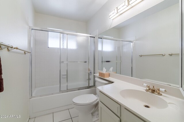 full bathroom with toilet, vanity, tile patterned floors, and shower / bath combination with glass door