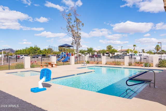 view of pool featuring a patio area and a playground