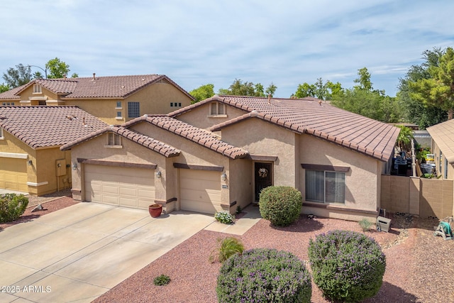 12936 W Flower St, Avondale, AZ 85392 - mediterranean / spanish-style house with an attached garage, stucco siding, driveway, fence, and a tiled roof