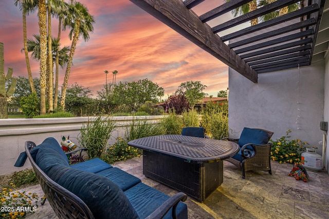 patio terrace at dusk featuring a pergola