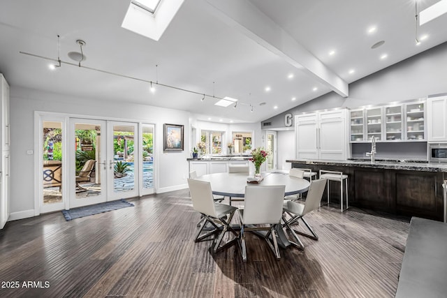 dining room featuring a skylight, dark wood-type flooring, baseboards, recessed lighting, and french doors