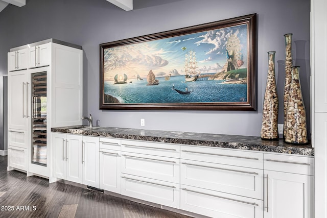 detailed view of wood finished floors and bar with sink