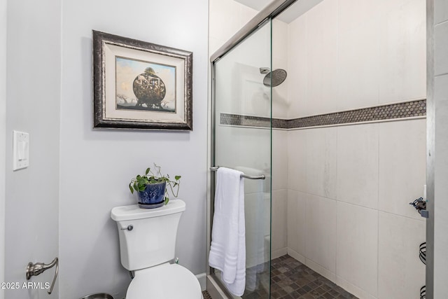 bathroom with a stall shower and toilet