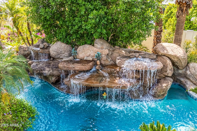 exterior view of a pool and a garden pond