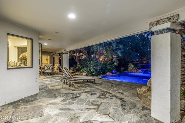 view of patio with an outdoor pool