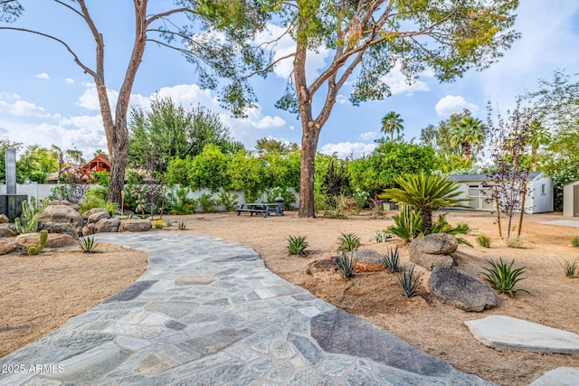surrounding community with an outdoor structure, a storage unit, and fence