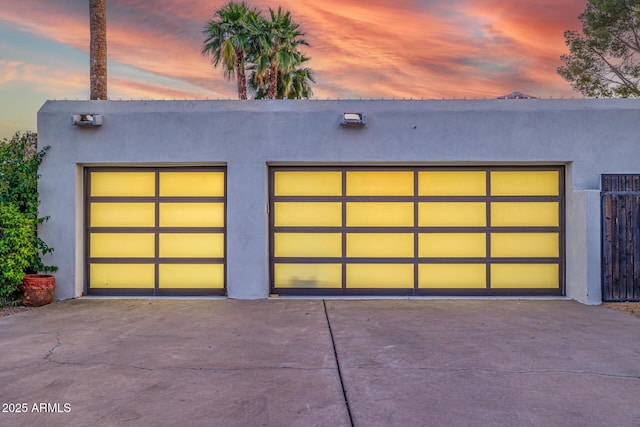 garage featuring concrete driveway