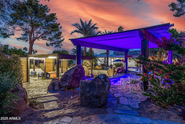 patio terrace at dusk with an outdoor pool