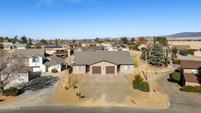 view of front of home featuring a mountain view and a garage