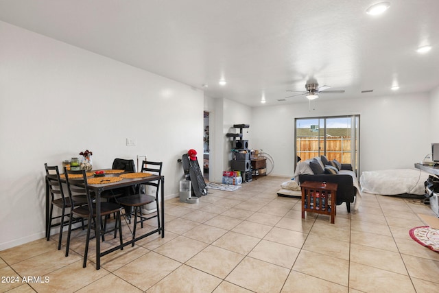 tiled dining space featuring ceiling fan