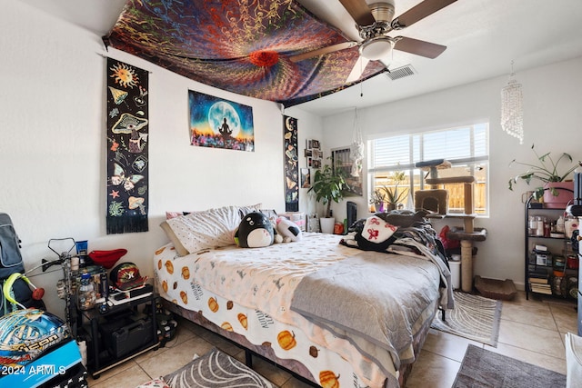 tiled bedroom featuring ceiling fan