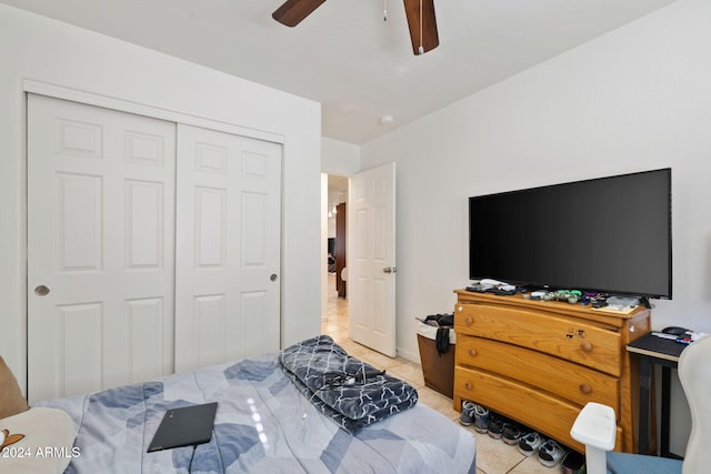 tiled bedroom with a closet and ceiling fan