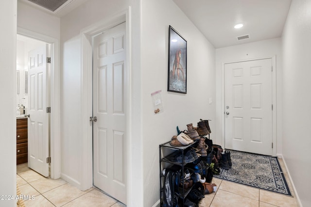 hallway featuring light tile patterned floors