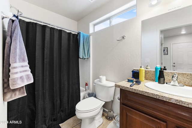 full bathroom featuring tile patterned floors, shower / tub combo with curtain, vanity, and toilet