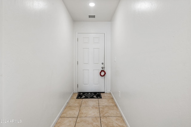 entryway with light tile patterned flooring