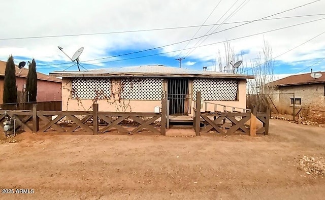 rear view of property with fence