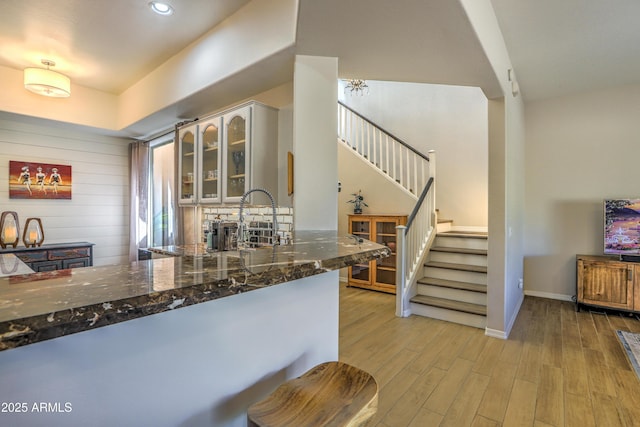 kitchen featuring dark stone countertops and light hardwood / wood-style floors