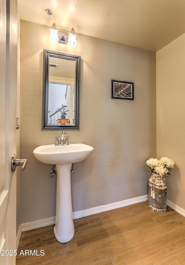 bathroom featuring hardwood / wood-style flooring and sink