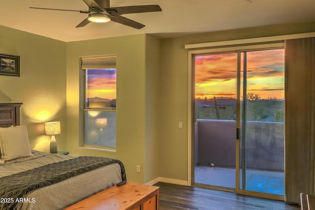 bedroom with dark hardwood / wood-style floors, access to outside, and ceiling fan