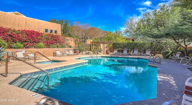 view of swimming pool with a community hot tub and a patio