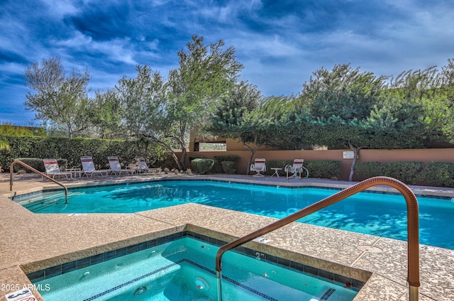 view of swimming pool with a community hot tub