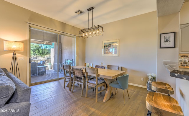 dining space with hardwood / wood-style floors