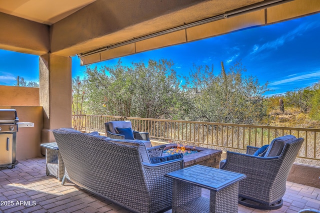 wooden terrace featuring a patio and an outdoor living space with a fire pit