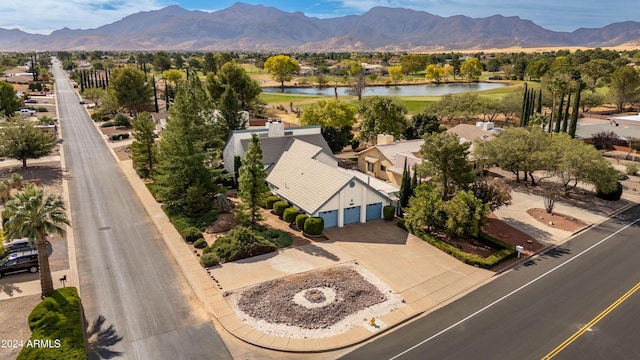 birds eye view of property with a water and mountain view