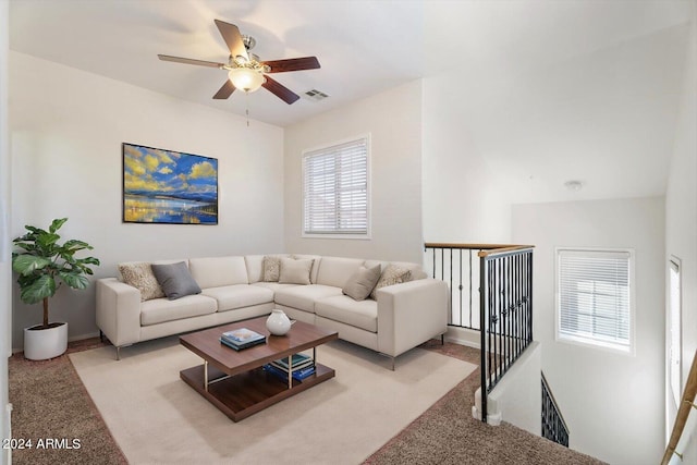 living room featuring plenty of natural light, ceiling fan, and light carpet