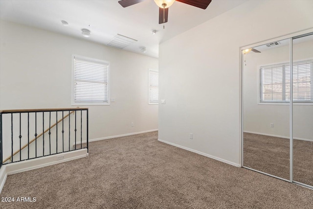 carpeted empty room with ceiling fan