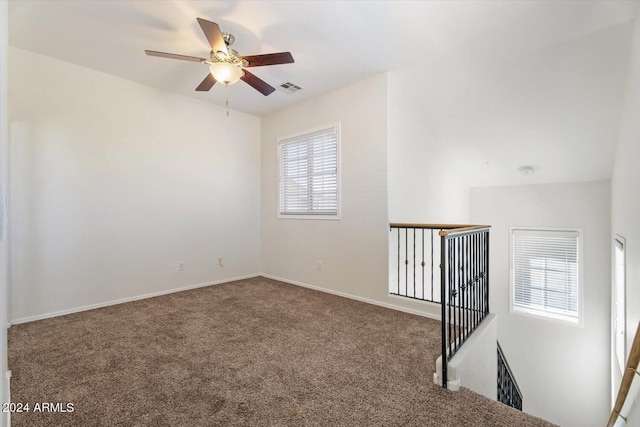 spare room featuring carpet flooring and ceiling fan