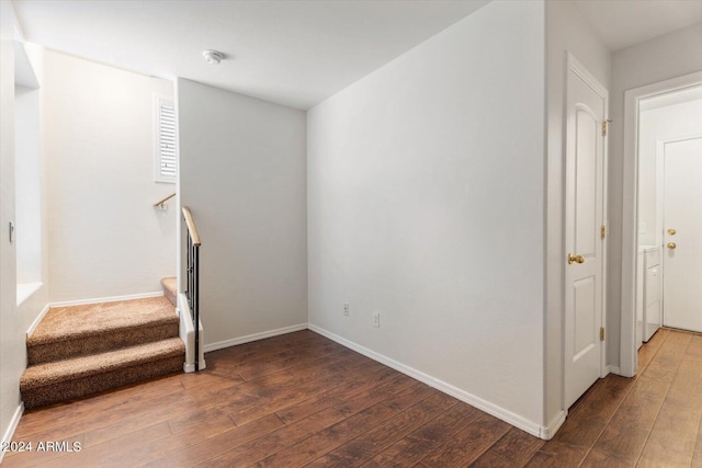 stairway with hardwood / wood-style floors