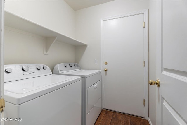 clothes washing area with independent washer and dryer and dark wood-type flooring