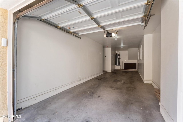 garage featuring electric water heater and a garage door opener