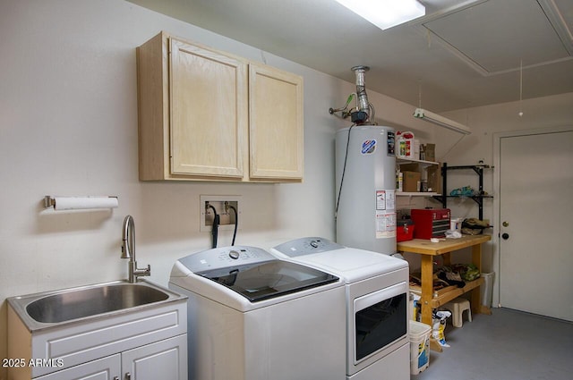 washroom featuring attic access, cabinet space, a sink, gas water heater, and washing machine and dryer