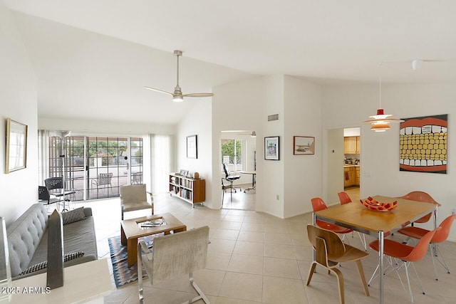 dining space featuring high vaulted ceiling, light tile patterned flooring, visible vents, and ceiling fan