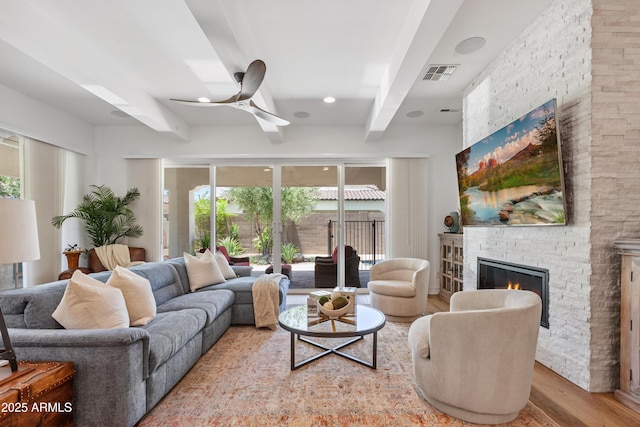 1948 W Paso Trl, Phoenix, AZ 85085 - living area featuring beam ceiling, a fireplace, a ceiling fan, and wood finished floors