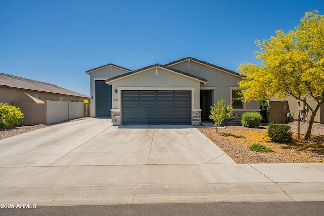 single story home featuring stucco siding, stone siding, concrete driveway, an attached garage, and fence
