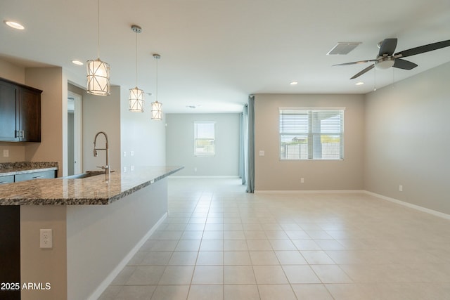 kitchen featuring recessed lighting, a sink, a ceiling fan, decorative light fixtures, and open floor plan