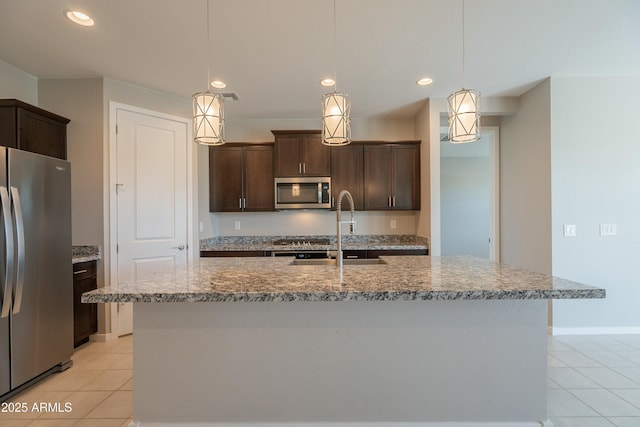 kitchen featuring light tile patterned floors, stainless steel appliances, recessed lighting, and dark brown cabinetry