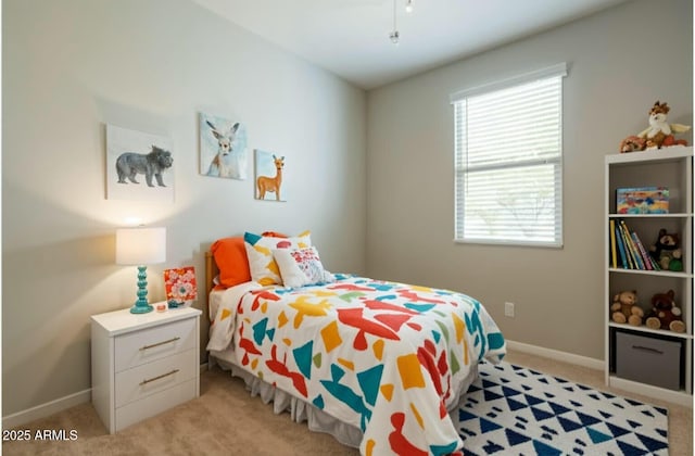 bedroom with baseboards and light carpet